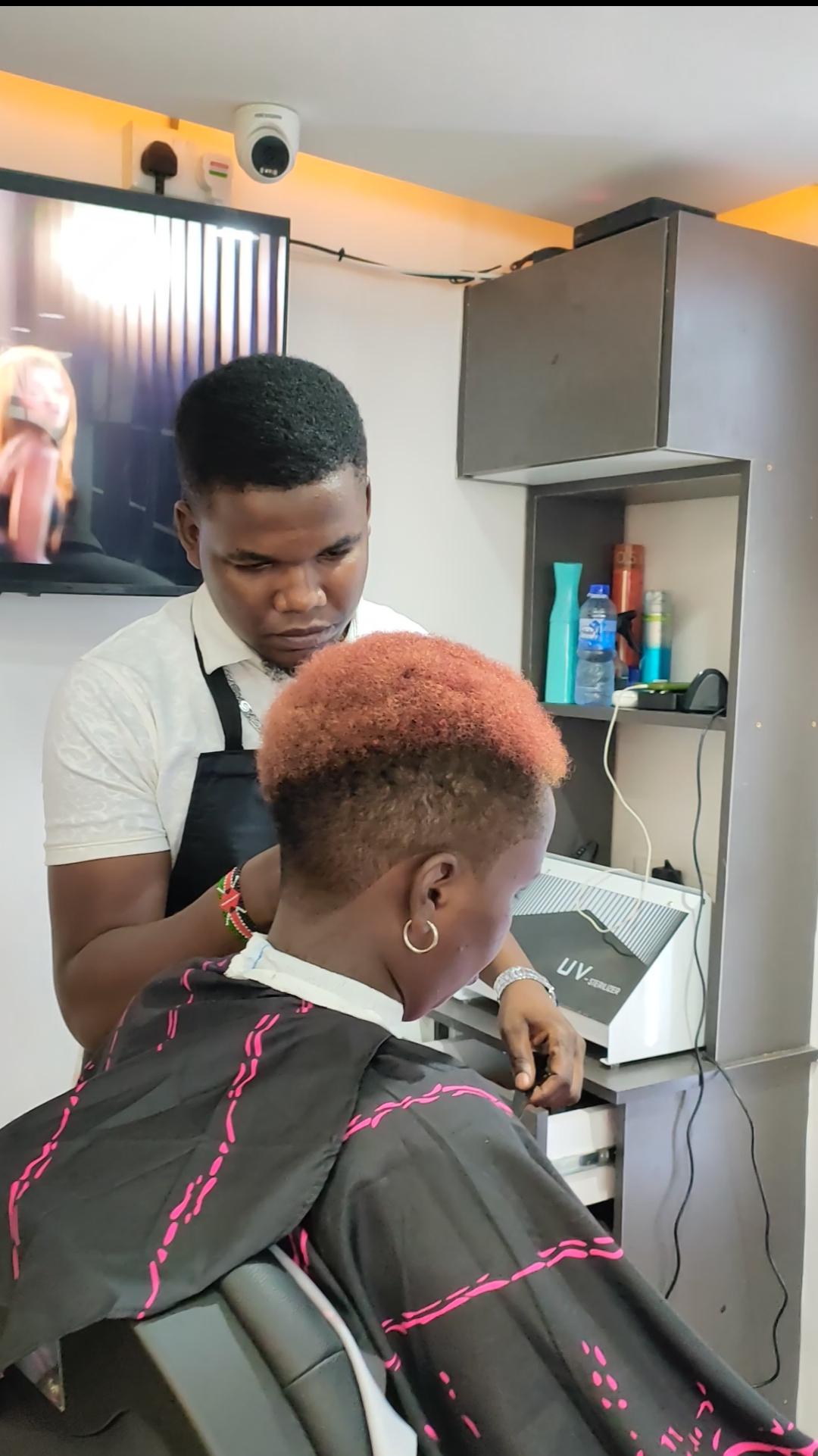 Barber styling colored hair at Maimo Mancave